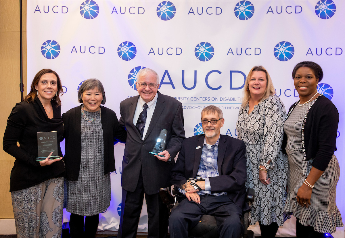 Image of a star shaped award with the AUCD banner behind it. 