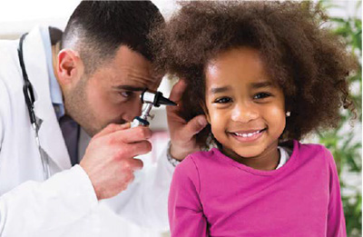 Iowa EPSDT Care for Kids newsletter photo, provider looking into child's ear with a medical instrument. 