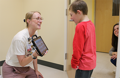 Young boy using ACC with their provider. 