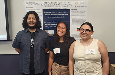 Paulette Nevarez, Cosette Tsai, and Abraham Venegas stand proudly in front of their poster detailing their work on the DISCAPAZ project.