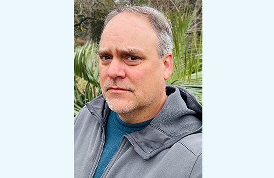 Steven Woltering, an older white man with short greying hair wearing a sweatershirt and tshirt.