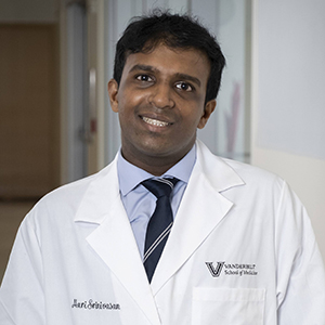 Image of Hari Srinivasan, an Indian man with black hair wearing a shirt, tie and lab coat.