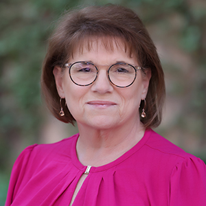 Wanda Felty, a white woman with shoulder length hair wearing glasses.