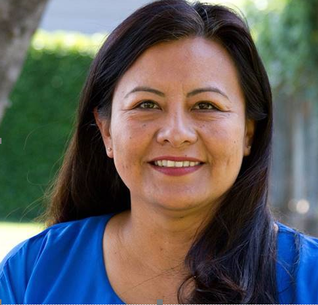 Headshot of Maribel Hernandez, a latin woman with shoulder-length hair wearing glasses and looking at the camera smiling.